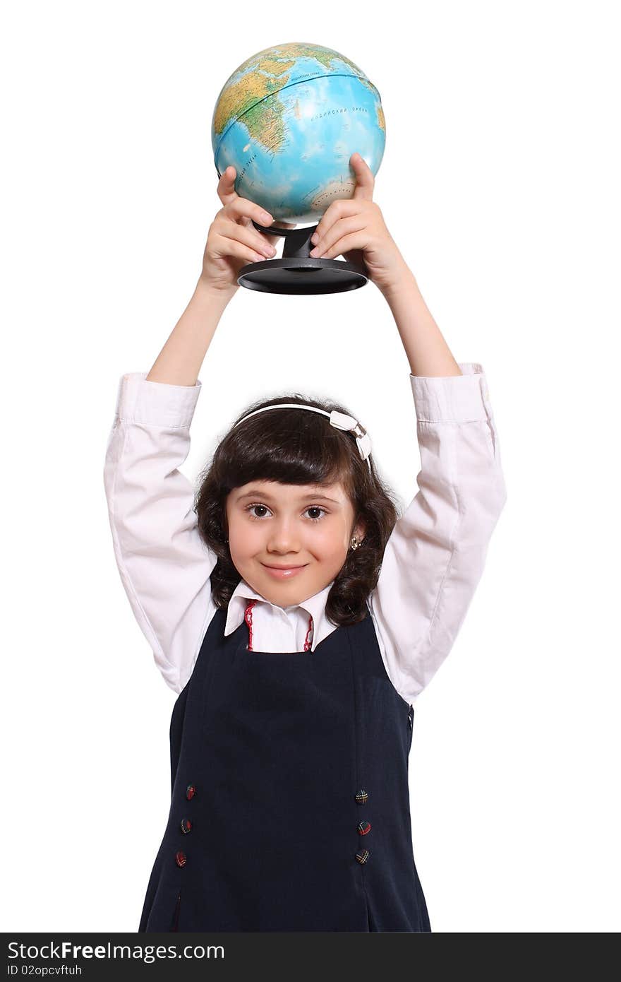 The small schoolgirl holds the globe the hands lifted above a head. The small schoolgirl holds the globe the hands lifted above a head