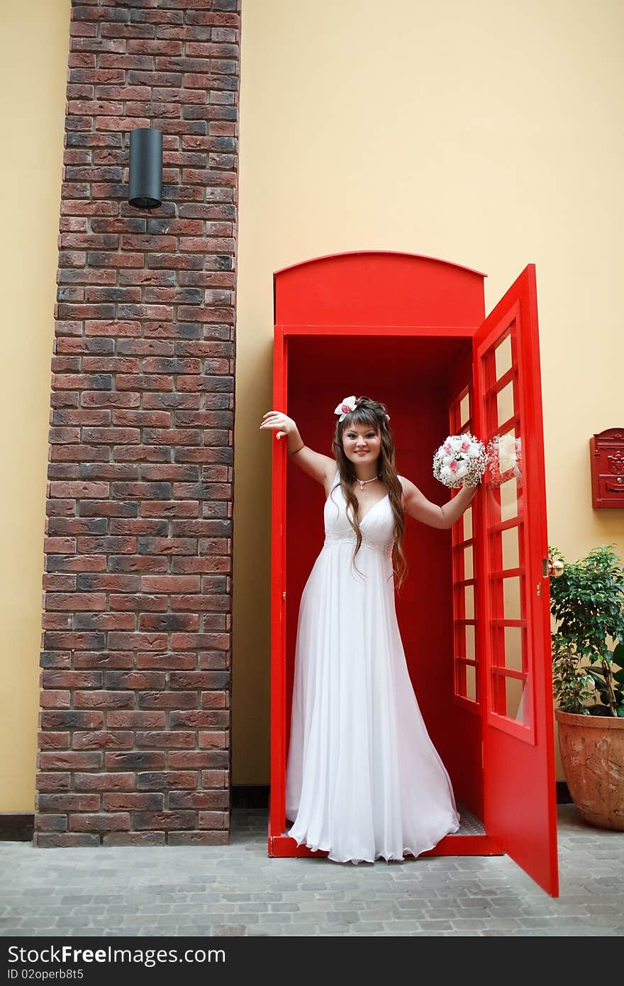 Bride in the telephone cabin