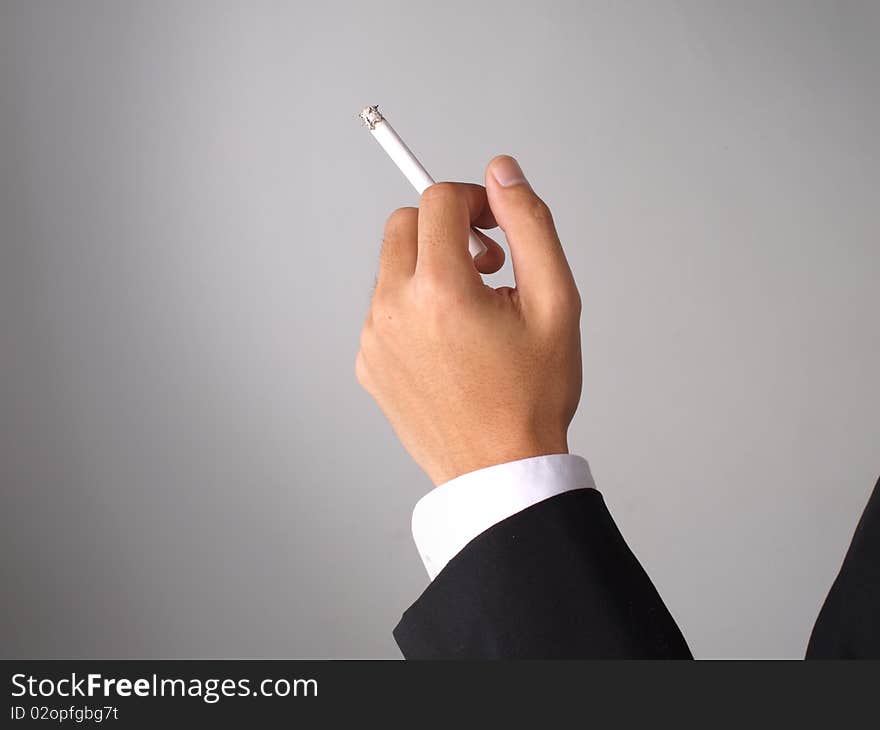 Businessman in coat holding a cigarette. Businessman in coat holding a cigarette