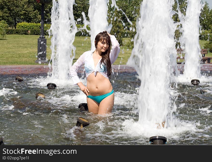 Girl bathing in a city fountain. Girl bathing in a city fountain