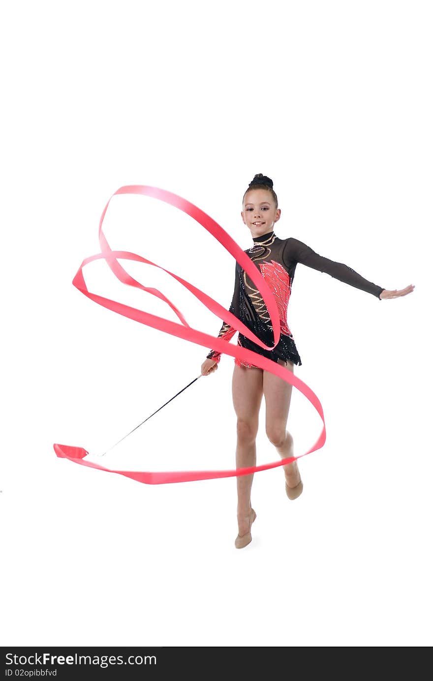 9 years old girl doing rhythmic gymnastics exercises with ribbon. 9 years old girl doing rhythmic gymnastics exercises with ribbon