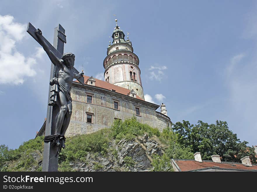 Crucifix and a chateau tower in cesky krumlov