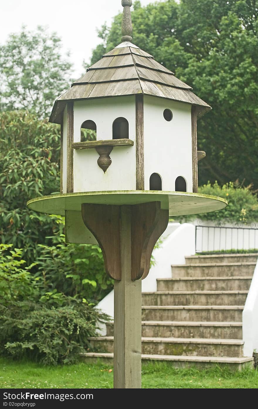 An image of a dove cote supported on a substantial pole in the garden. An image of a dove cote supported on a substantial pole in the garden.