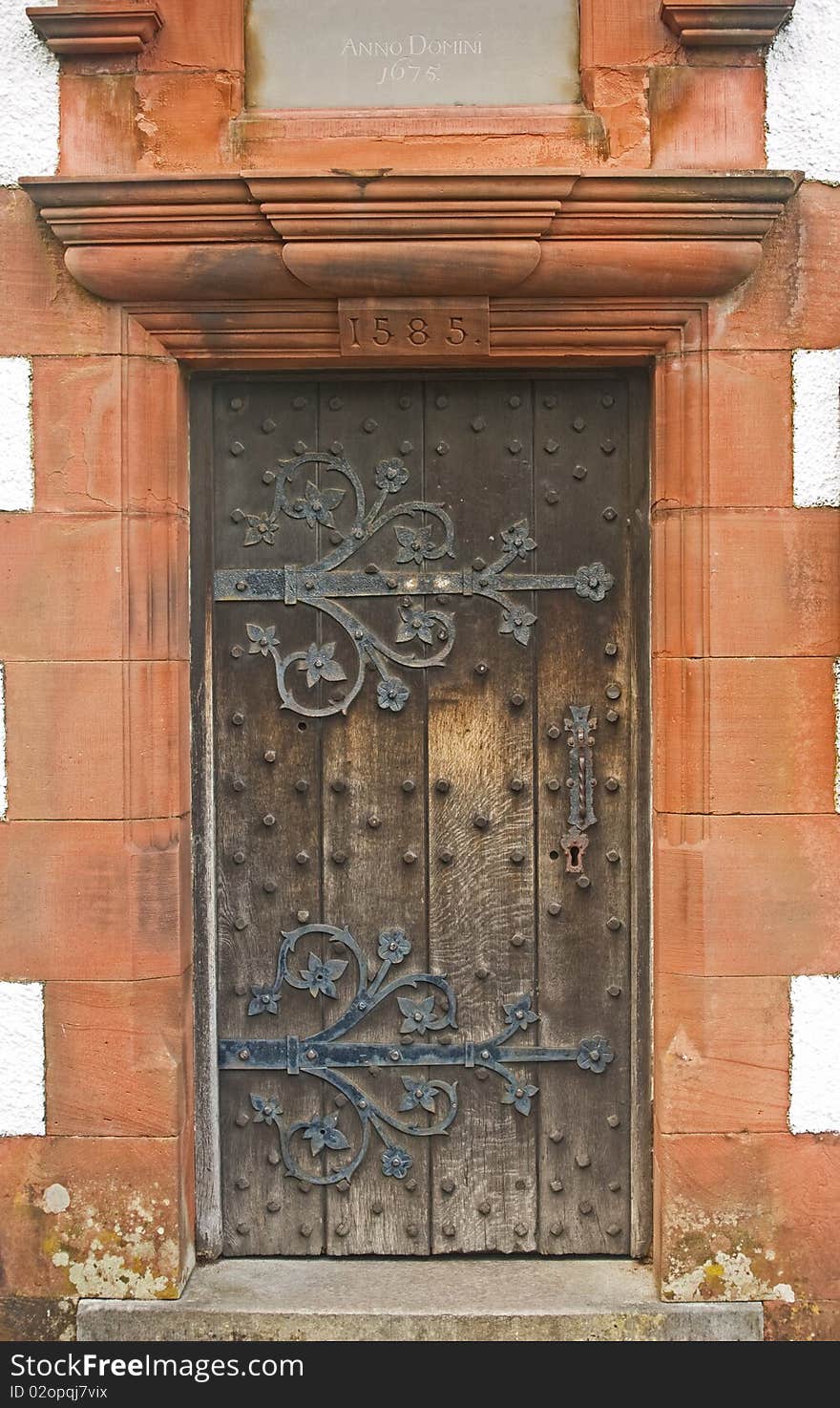 An image of an ancient , decorated, studded,  wooden door of an old church dated 1585. An image of an ancient , decorated, studded,  wooden door of an old church dated 1585.