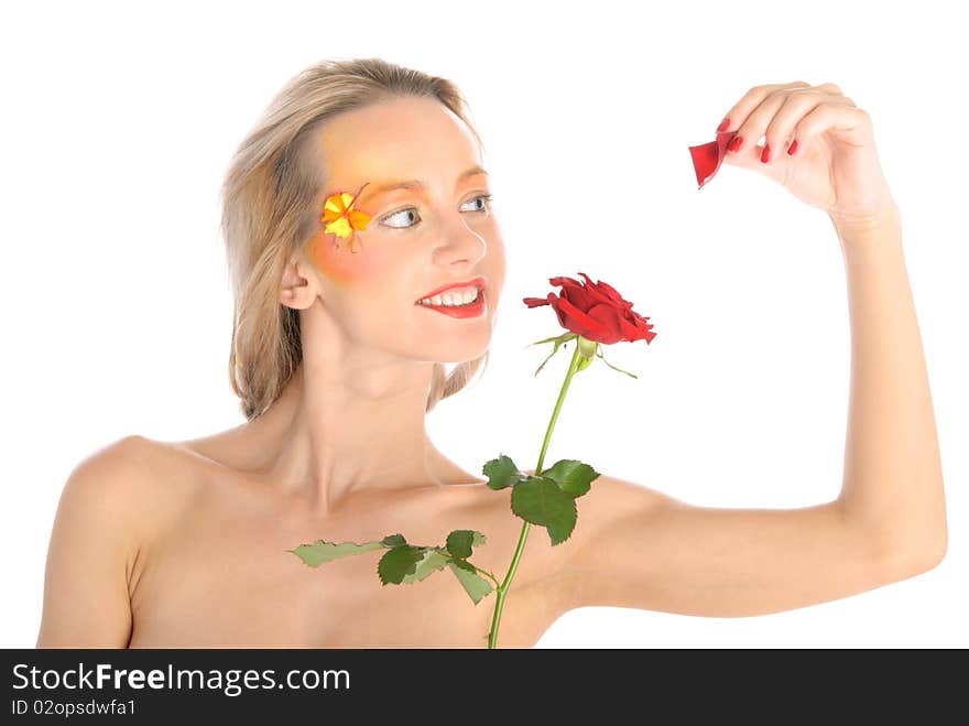 Young woman tears off petals at flower isolated in white