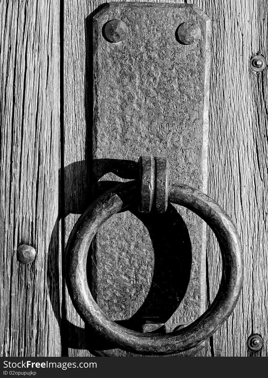 Old iron door handle on wooden door. Old iron door handle on wooden door