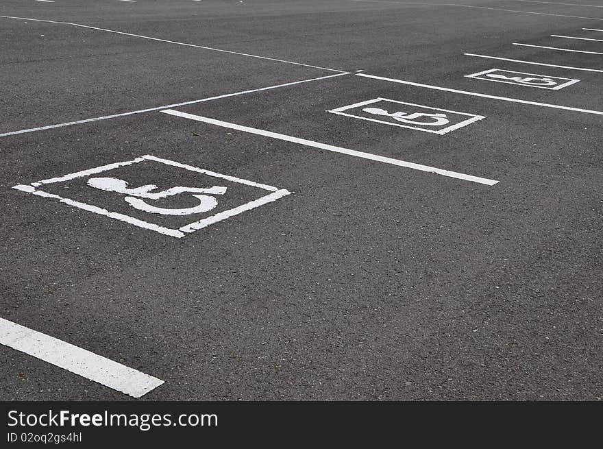 Wheel chair symbol with asphalt road