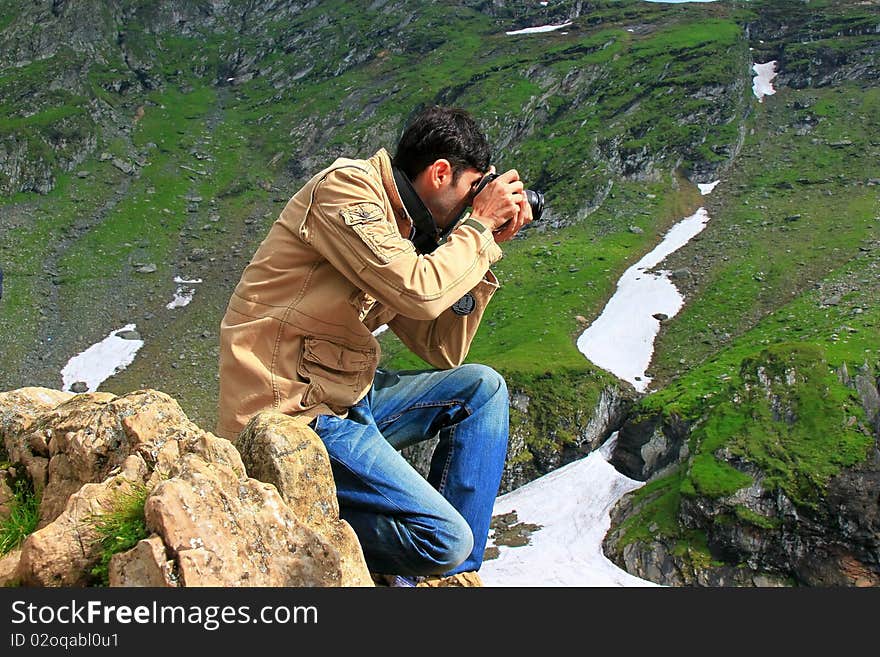 Photographer taking shots in the mountains