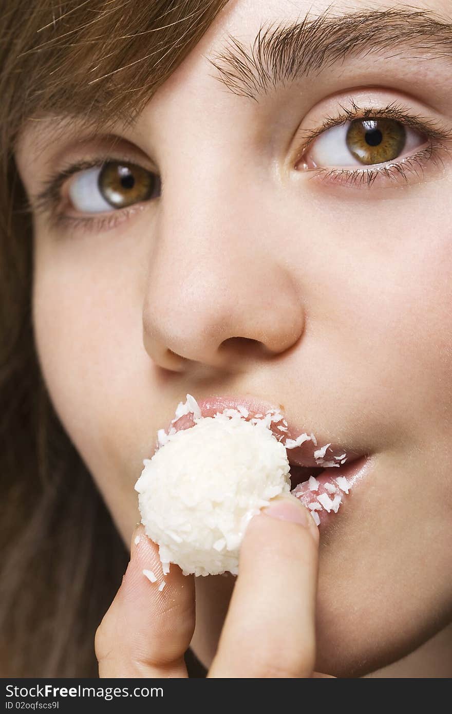 Sexy young woman biting white candy