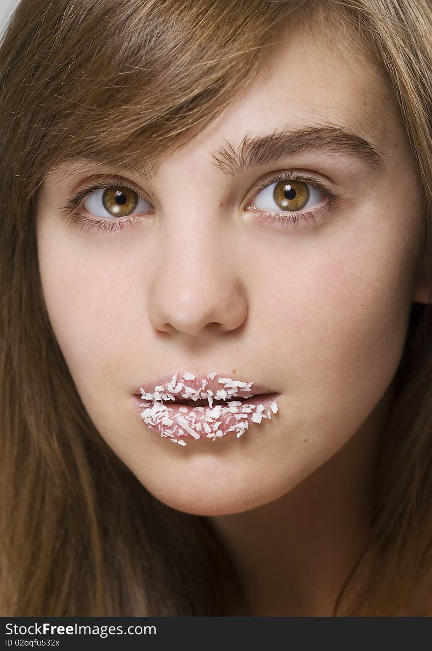 Girl with a coconut shaving on lips