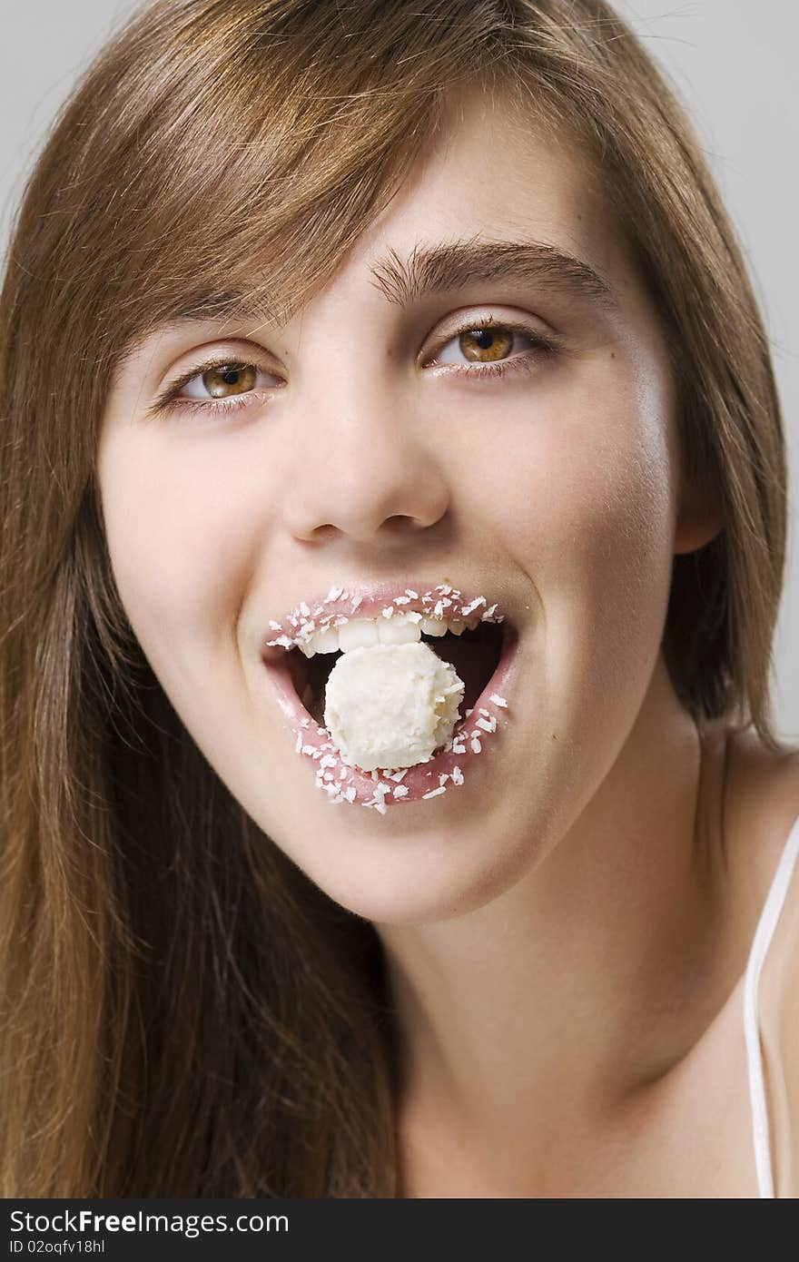 Woman biting white candy