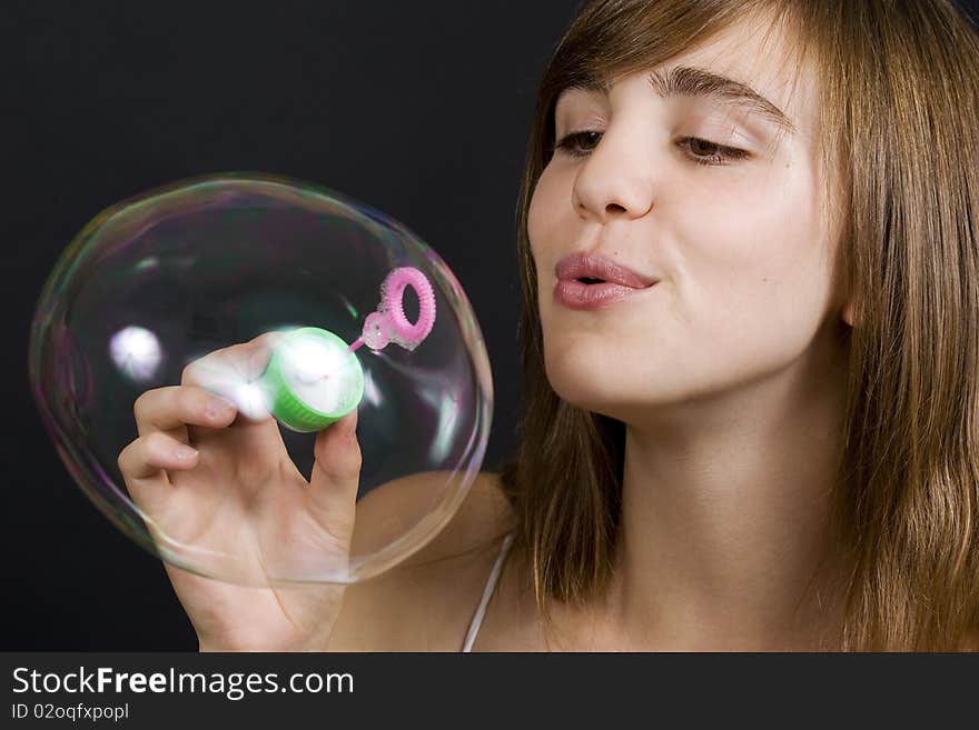 Young woman playing with bubbles. Young woman playing with bubbles