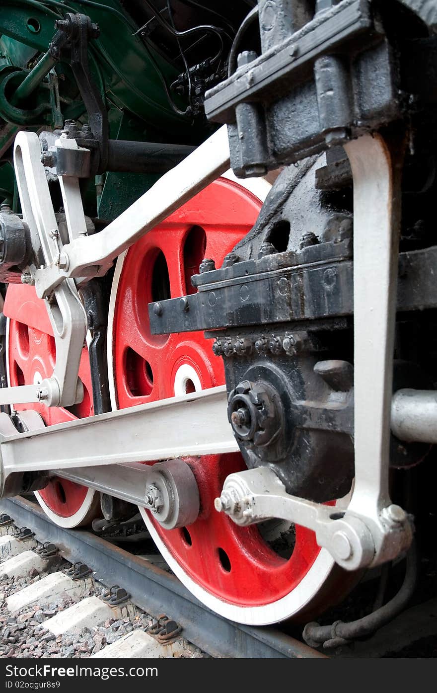 Old steam engine wheels close-up, vertical