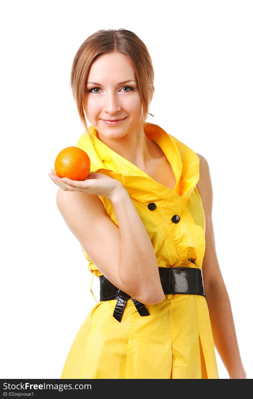 Young pretty girl in yellow dress with oranges