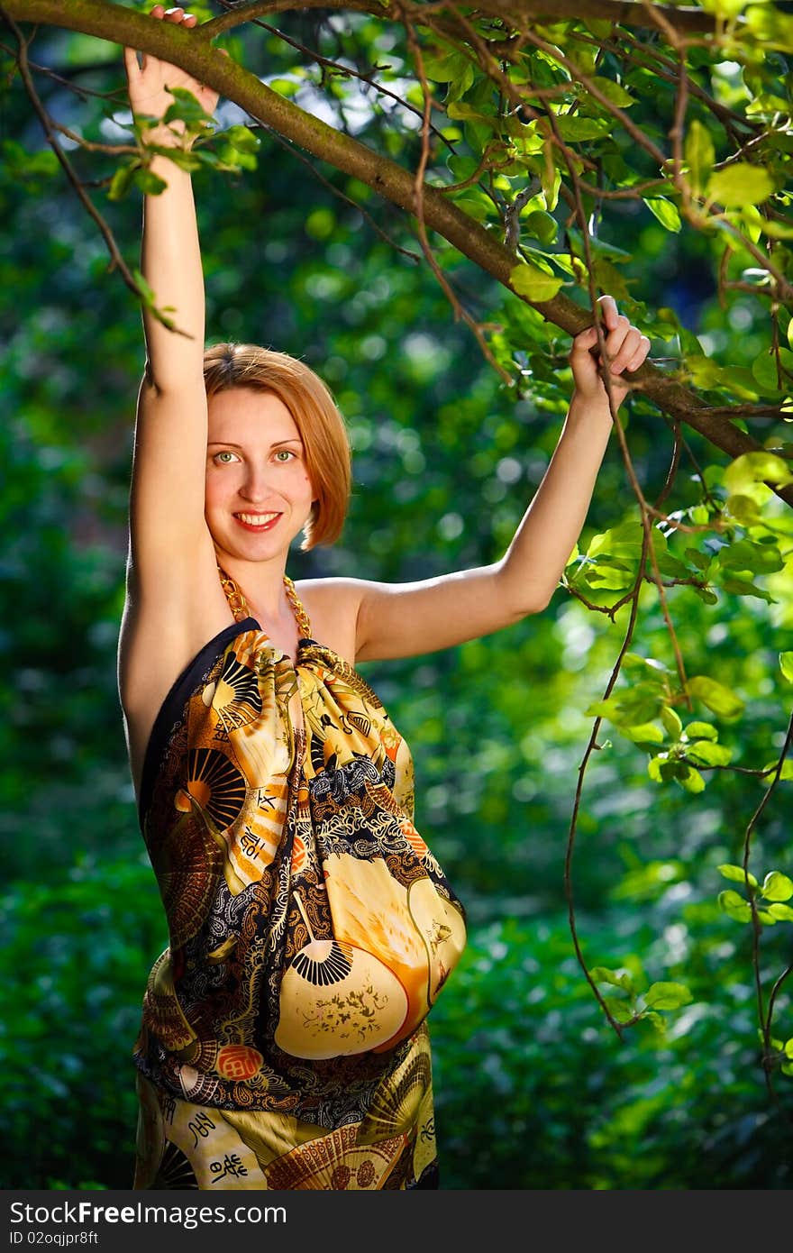 Attractive young woman holding branch og apple-tree. Attractive young woman holding branch og apple-tree