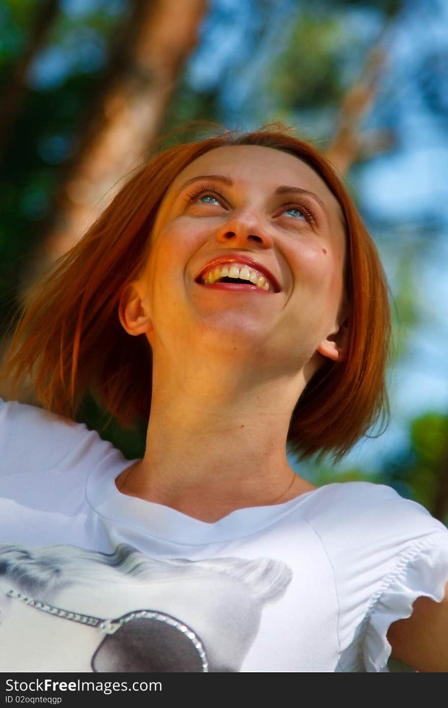 Portrait of young smiling woman with her eyes up. Portrait of young smiling woman with her eyes up