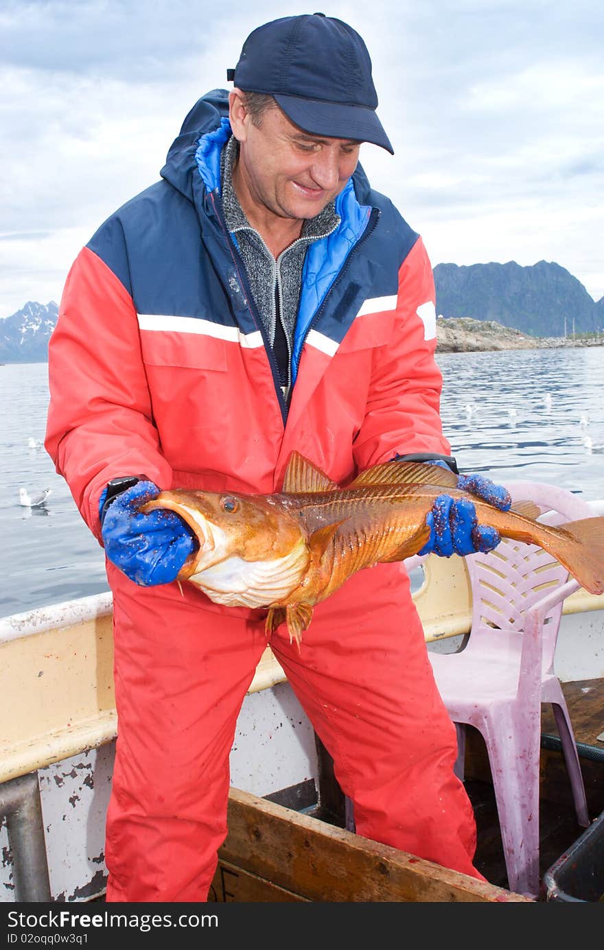 Fisherman with big fish on the boat