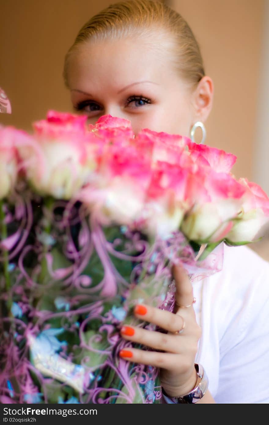 Girl sniffing beautiful flower - pink roses. Girl sniffing beautiful flower - pink roses