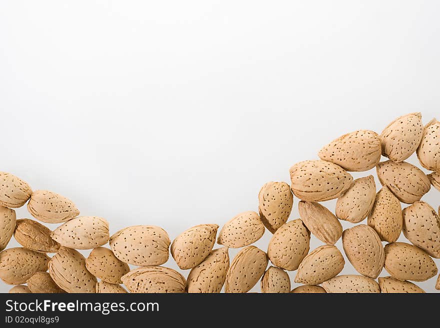 Almonds on white background wiht copy space. Almonds on white background wiht copy space.