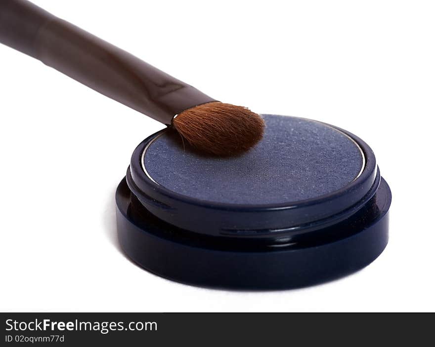 Blue eyeshadow and brush isolated on white