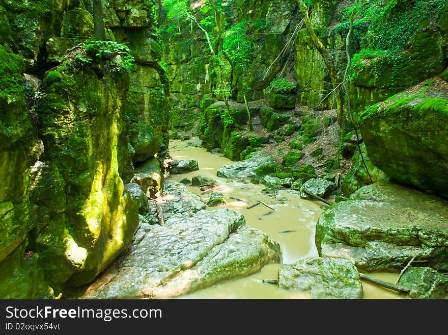 Gray river between green rocks, Hungary. Gray river between green rocks, Hungary