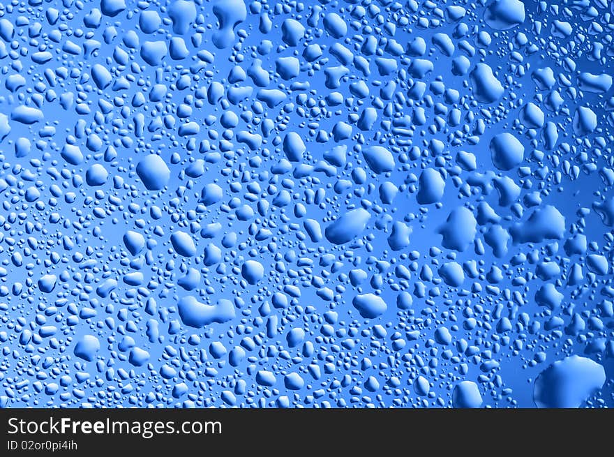 Blue water bubbles on the window for background. Blue water bubbles on the window for background