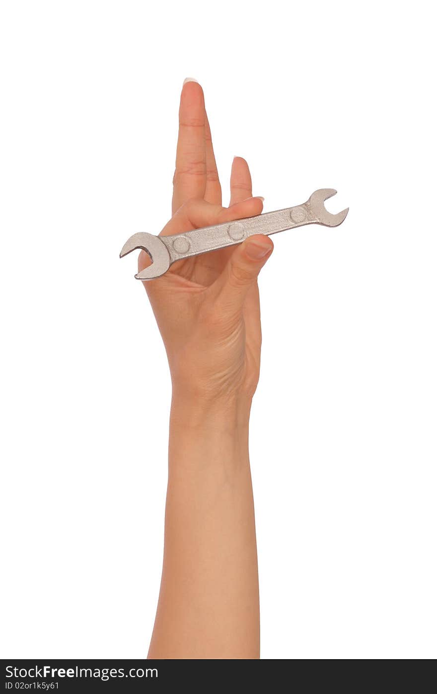 Woman holding small chrome vanadium spanner in the hands. Woman holding small chrome vanadium spanner in the hands