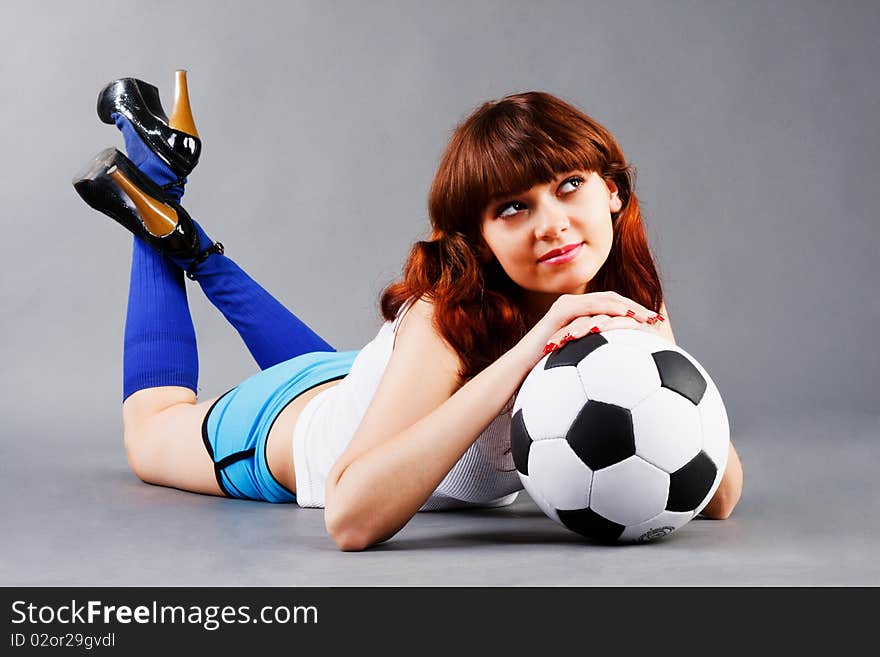 Lying young girl on floor with a soccer ball. Lying young girl on floor with a soccer ball