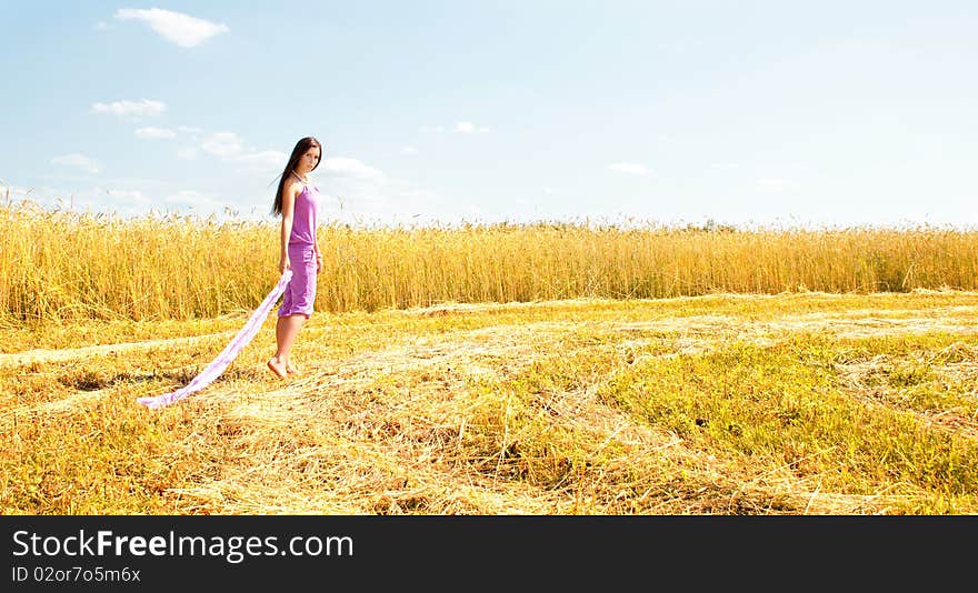 Beautiful lady walking in a field.