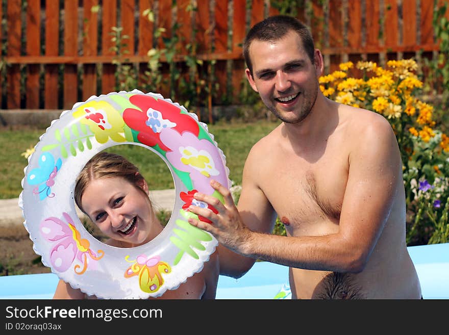 Young pair bathes in inflatable pool