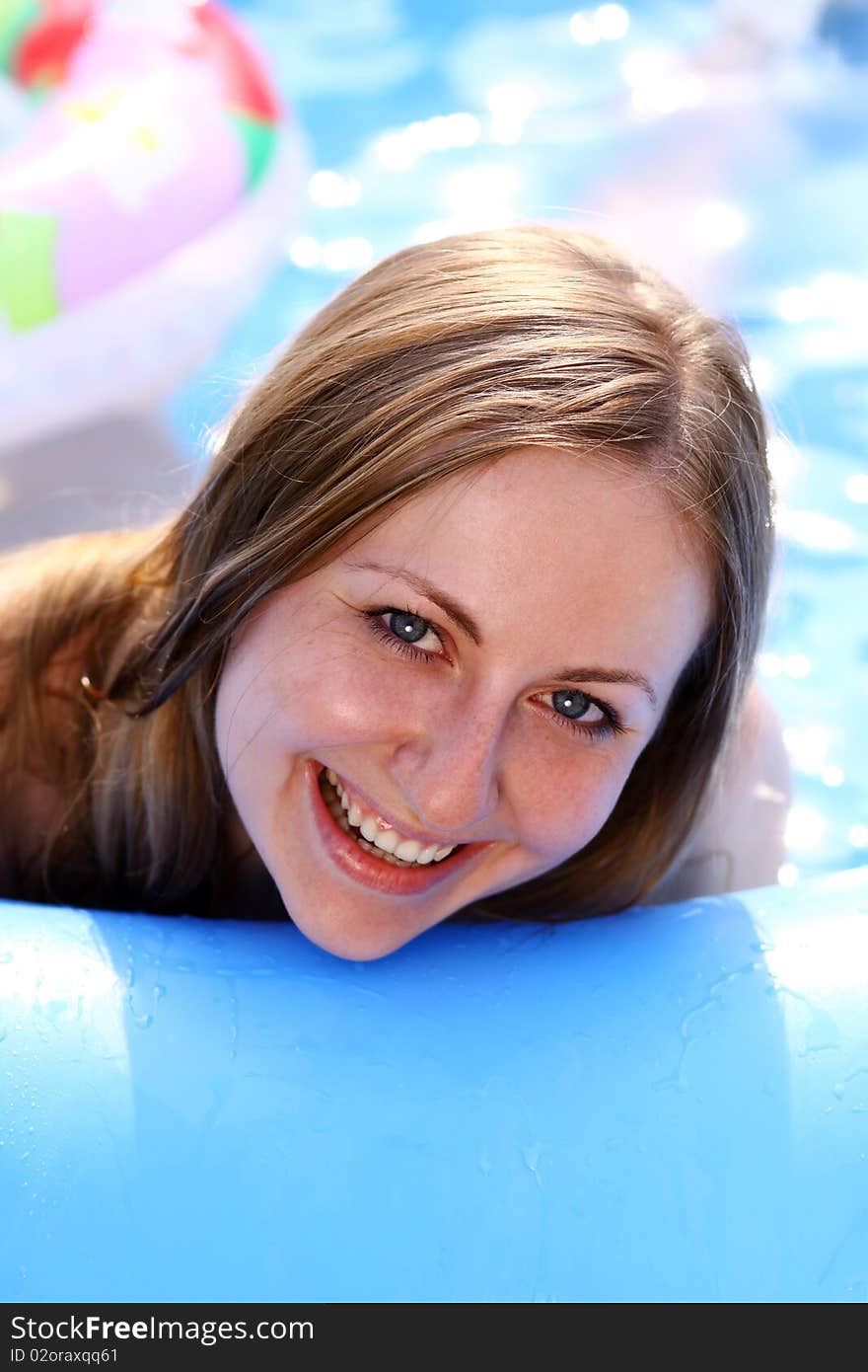 Portrait of a beautiful happy woman in swimming pool