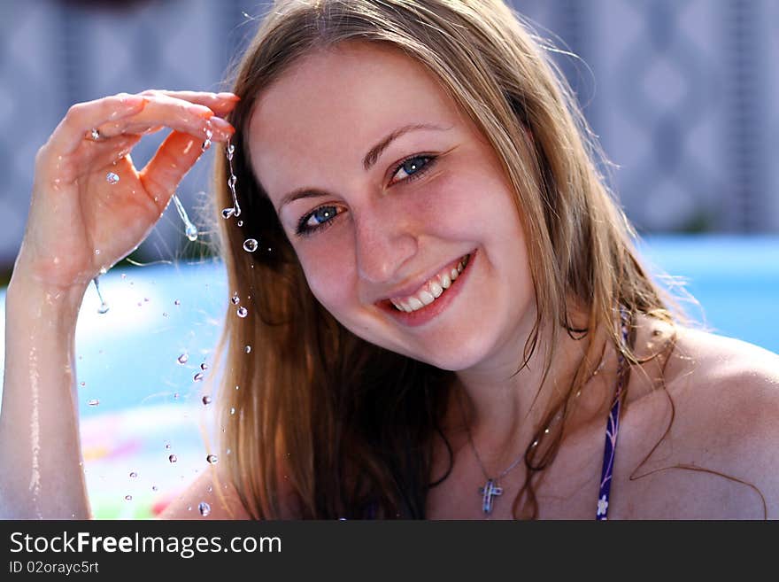 Portrait of a beautiful happy woman in swimming pool