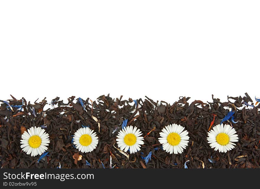 Flowers on the dry tea leaves background