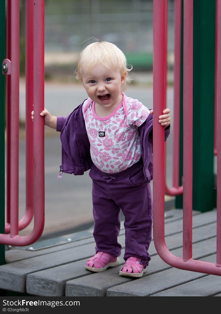 Portrait of the beautiful baby girl on playground