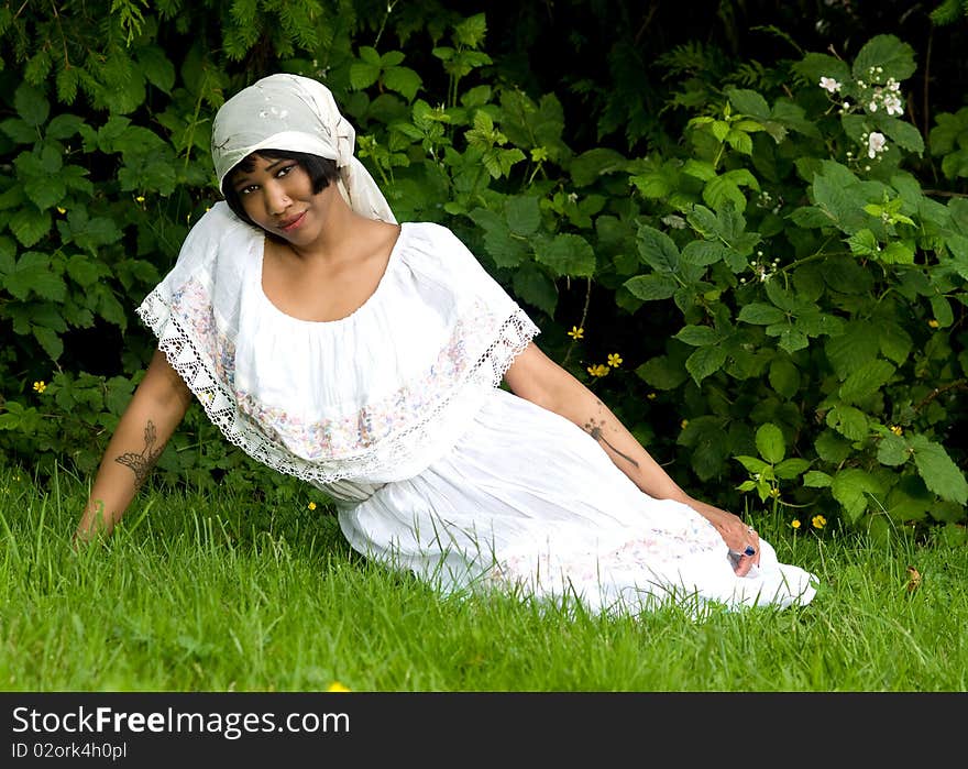 Beautiful black woman wearing scarf on head in nature setting. Beautiful black woman wearing scarf on head in nature setting