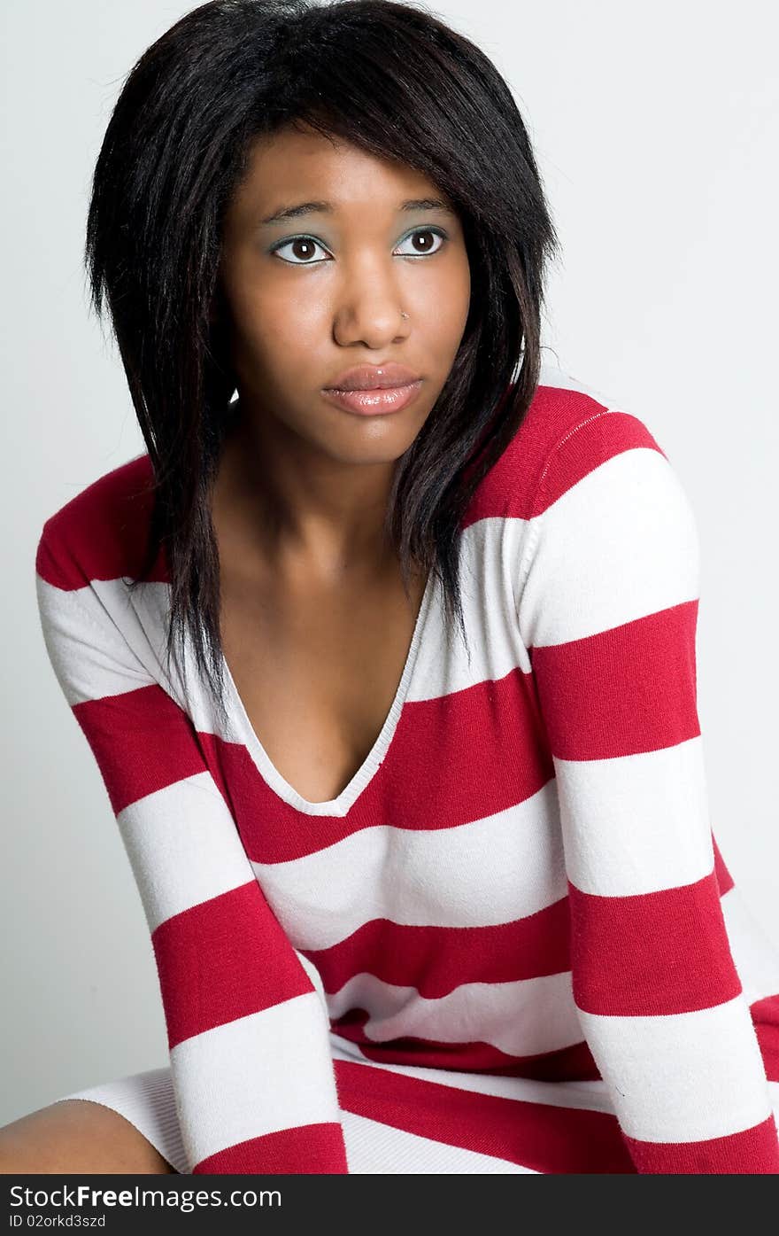 Beatiful young black model posing in striped sweater. Beatiful young black model posing in striped sweater