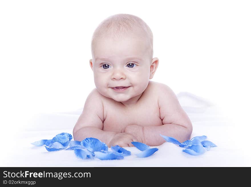 Beautiful baby under a white towel on white background