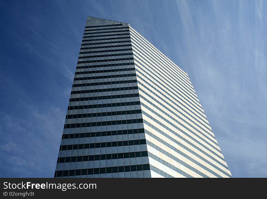 A tall building rising up in the clouds. A tall building rising up in the clouds