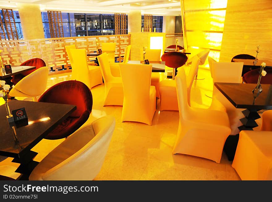 Luxury hotel cafeteria,sofas and wood table with soft yellow lighting. Luxury hotel cafeteria,sofas and wood table with soft yellow lighting.