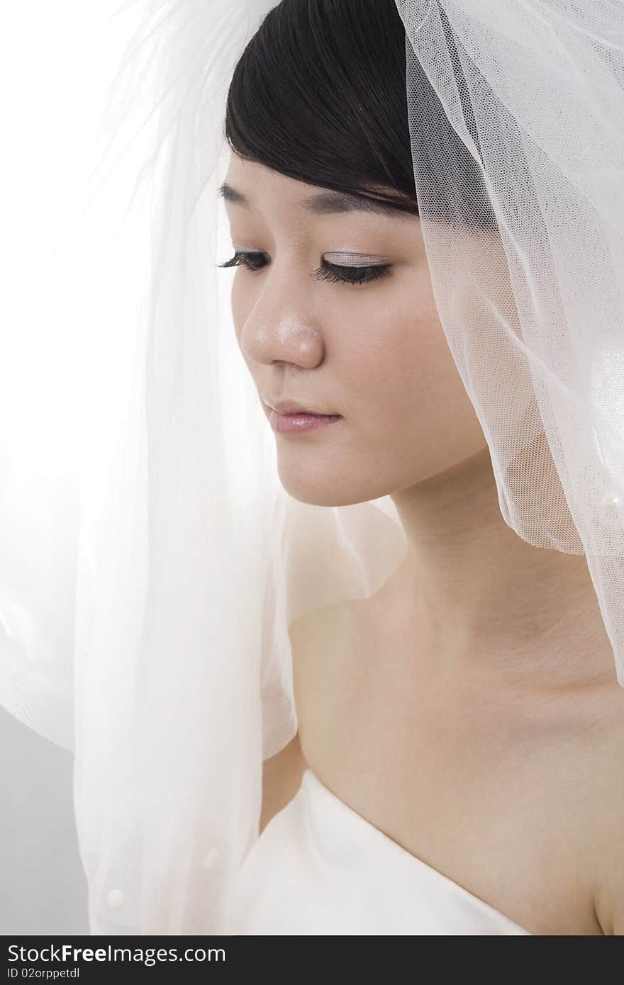 Beautiful bride with perfect natural makeup,smiling,wearing mantilla