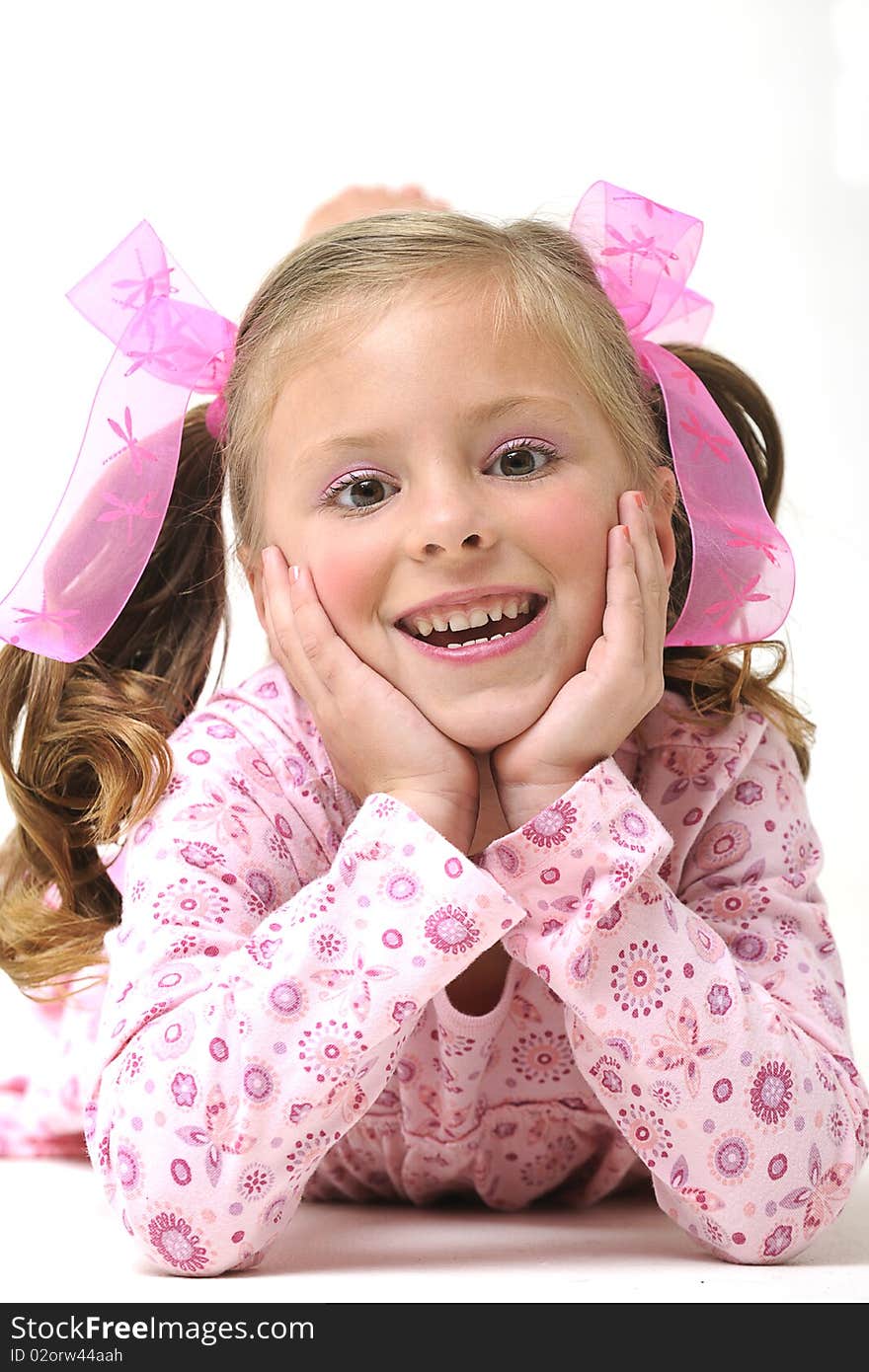 Young pretty blond girl laying on the floor and smiling