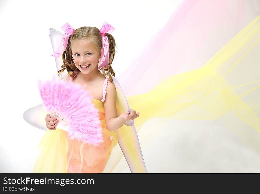 Young pretty blond girl standing with angle wings and a pink Chinese fan. Young pretty blond girl standing with angle wings and a pink Chinese fan