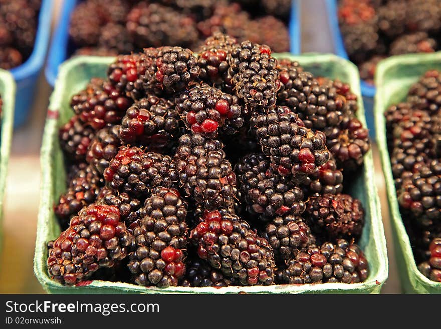 Blackberries in baskets in a farmers  market