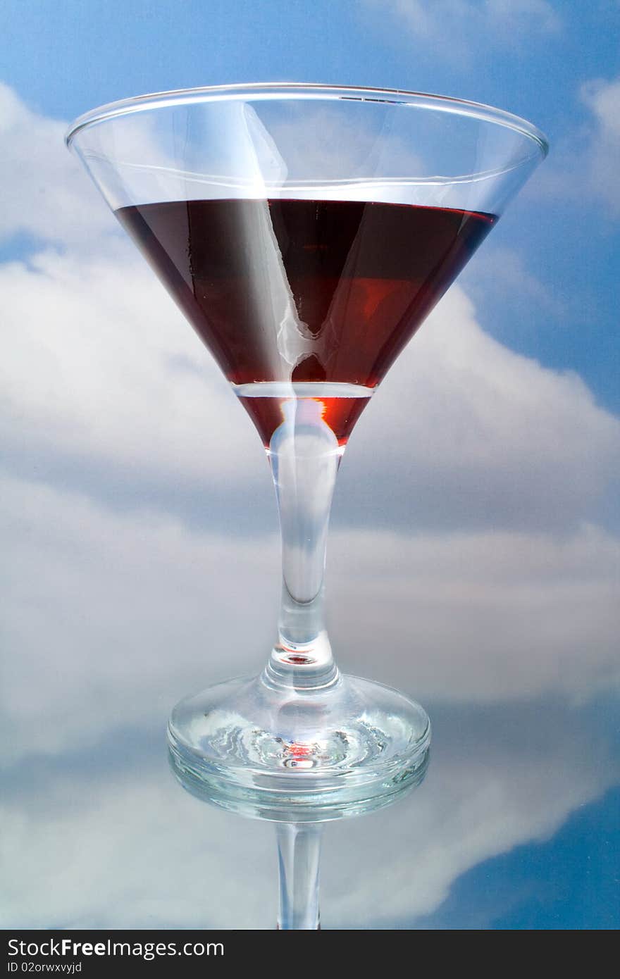 Red wine in glass on a background sky