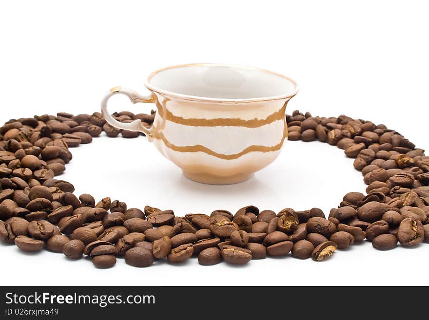 Grains of coffee and cup on a white background