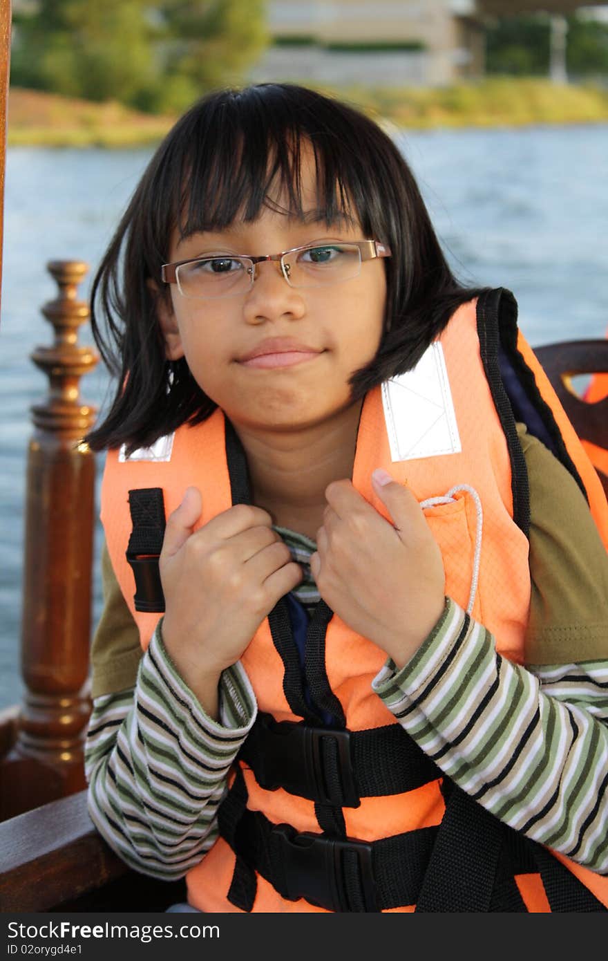 A picture of friendly looking Asian teenage girl at a local watersports arena. A picture of friendly looking Asian teenage girl at a local watersports arena.