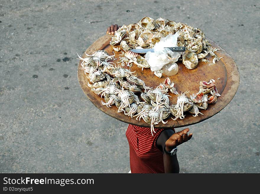 Woman selling crab meat on the street in africa. Woman selling crab meat on the street in africa