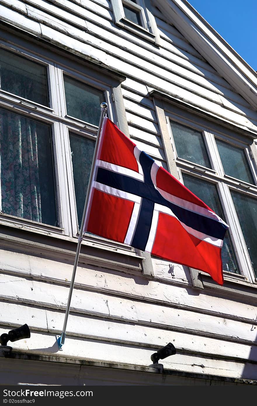 Norwegian Flag flies from an old timber house in Bryggen