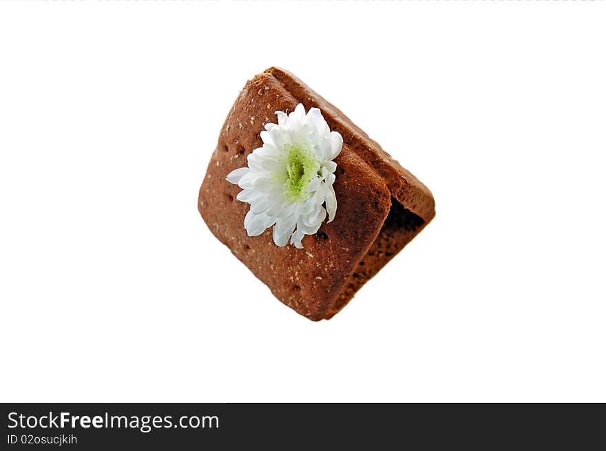 House of slices of black bread and white chrysanthemum flowers instead of a chimney. House of slices of black bread and white chrysanthemum flowers instead of a chimney