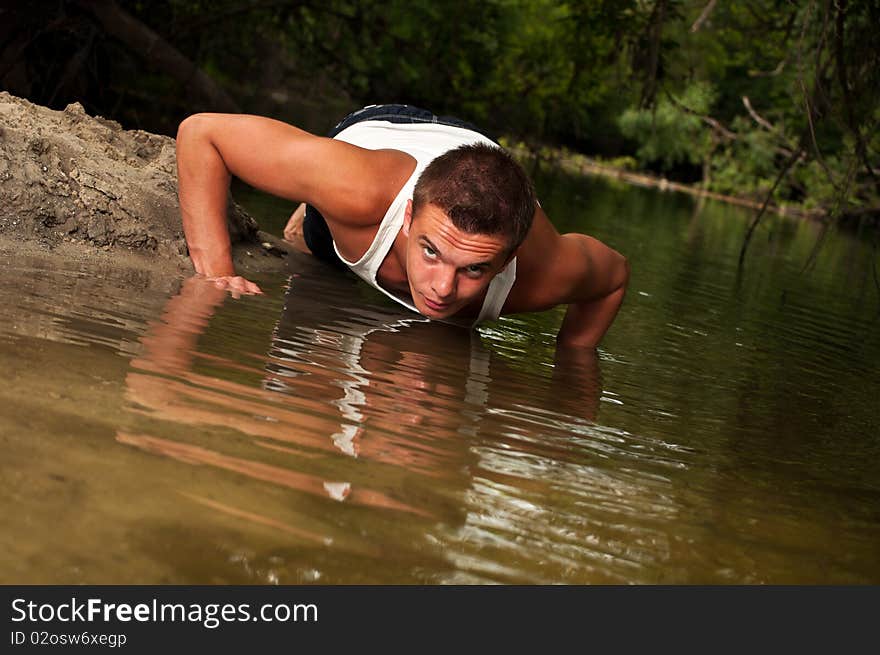 Man doing push-ups on the beach